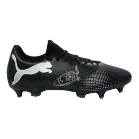 Black Puma soccer boot with a white logo on the side and a textured upper, shown from the side with studs on the bottom edges.