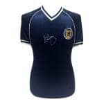 Autographed navy blue football jersey with white trim and a crest on the left chest, displayed on a mannequin