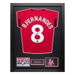 Framed Manchester United jersey #8 with Bruno Fernandes signature, flanked by two photos and a small name plaque.