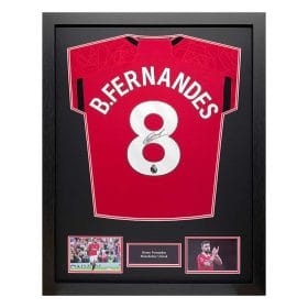 Framed Manchester United jersey #8 with Bruno Fernandes signature, flanked by two photos and a small name plaque.