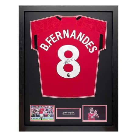 Framed Manchester United jersey #8 with Bruno Fernandes signature, flanked by two photos and a small name plaque.