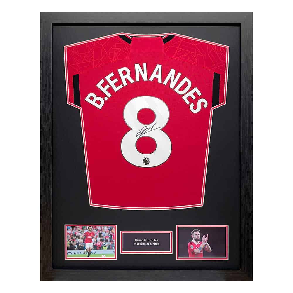 Framed Manchester United jersey #8 with Bruno Fernandes signature, flanked by two photos and a small name plaque.