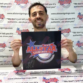 Man smiling while holding a black poster featuring the Allstar Signings logo, in front of an Allstar Signings backdrop.