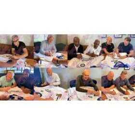 Collage of several men seated at a table signing white sports jerseys with blue logos and 'All-Star' watermarks on the fabric.