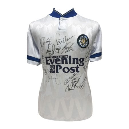 White Leeds United jersey with blue trim, covered in signatures, featuring Evening Post sponsor logo.