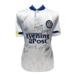 White signed football shirt with club crest on chest, Yorkshire Evening Post sponsor logo, and blue-yellow sleeve accents; numerous autographs across the front.