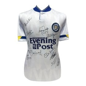 White signed football shirt with club crest on chest, Yorkshire Evening Post sponsor logo, and blue-yellow sleeve accents; numerous autographs across the front.